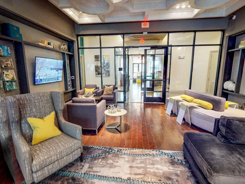 The Civic At Frisco Square apartment clubhouse with large television, couches and chairs