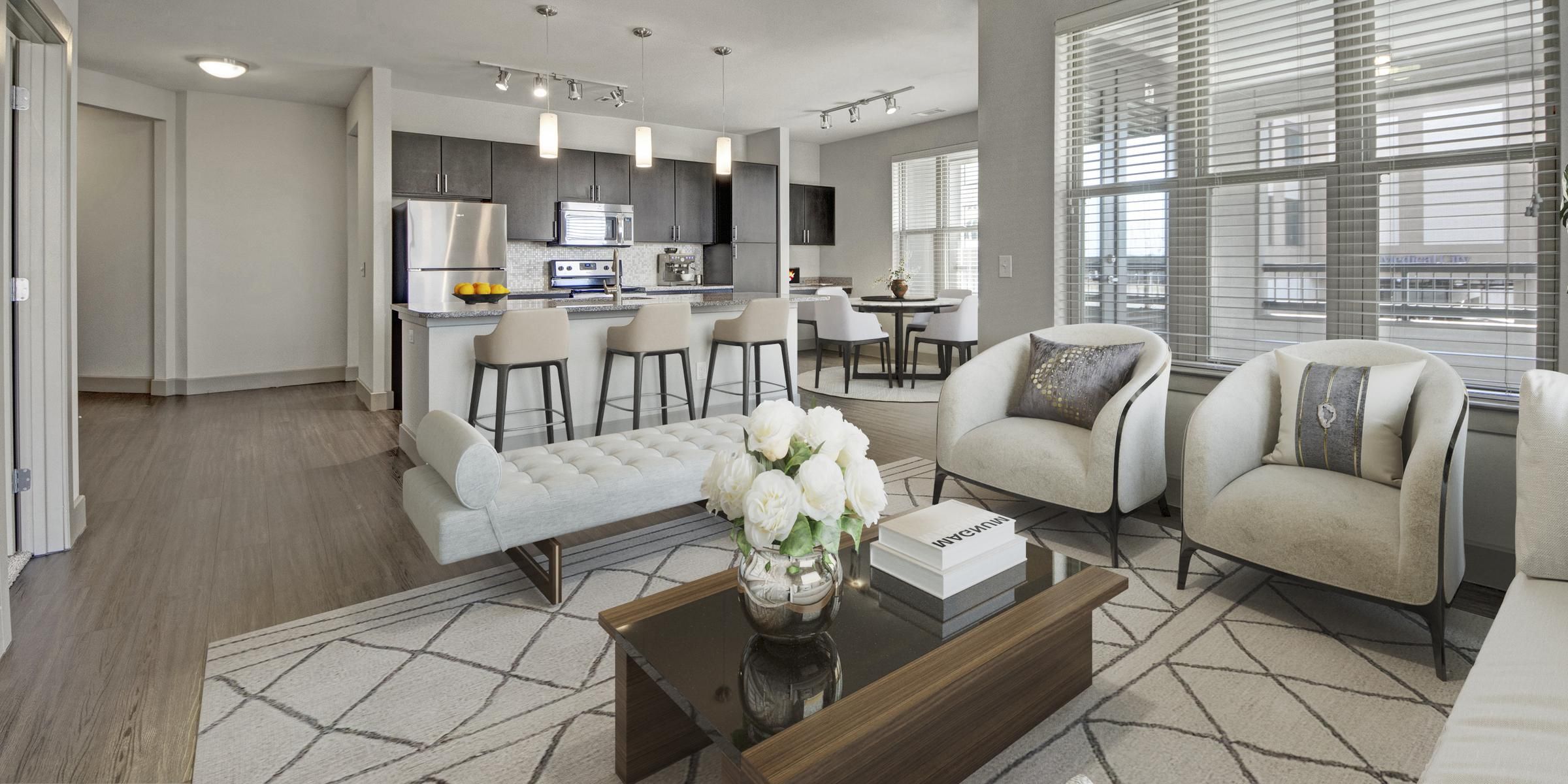 Luxury apartment living room with large windows, wood style floors and contemporary furniture at The Civic at Frisco Square