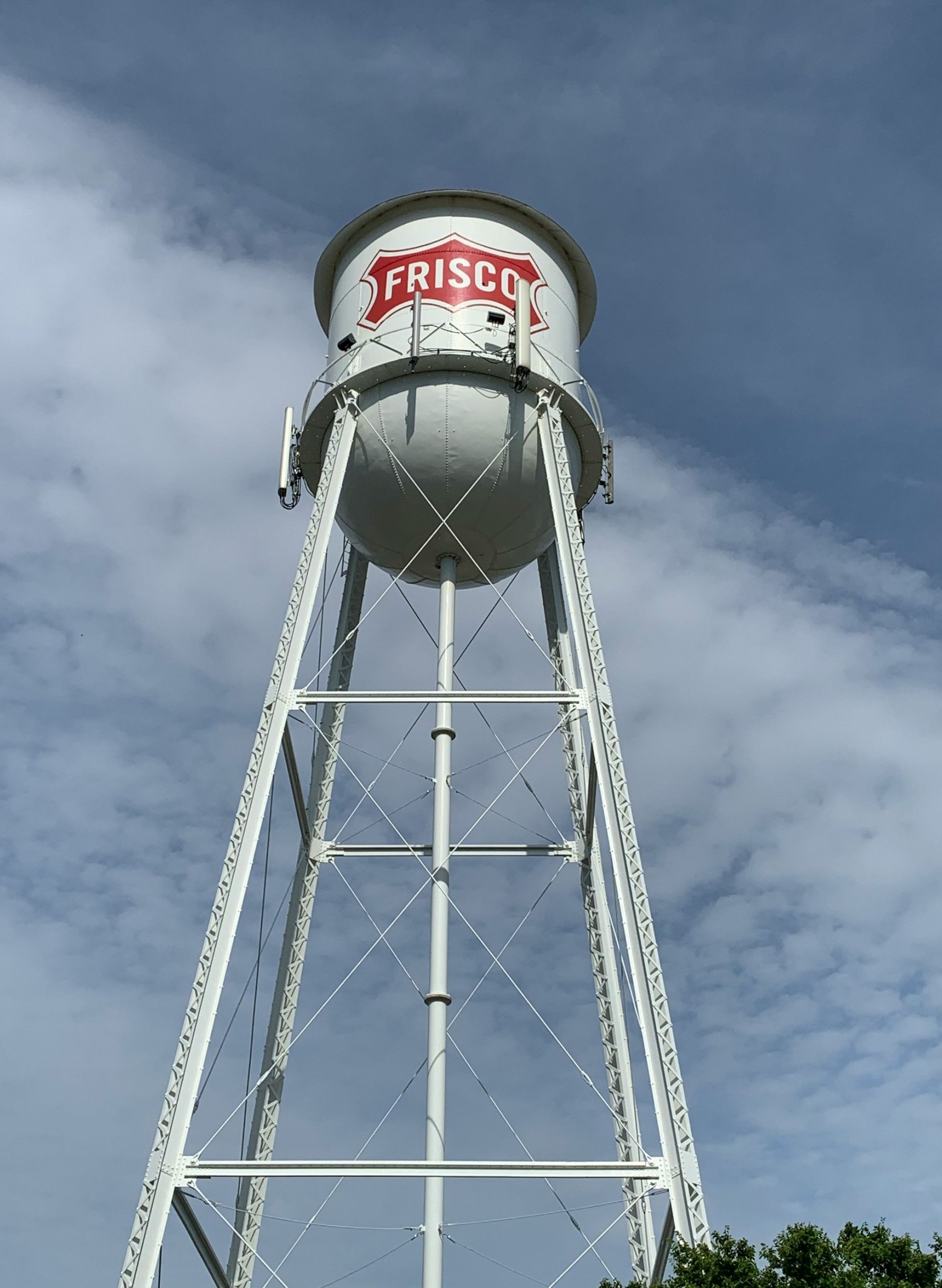 White water tower with red sign in Frisco, TX