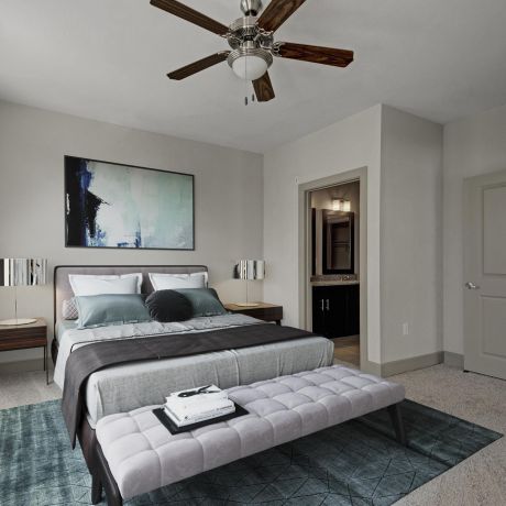 The Civic at Frisco Square apartment bedroom with large floor plan, ceiling fan, and king sized bed