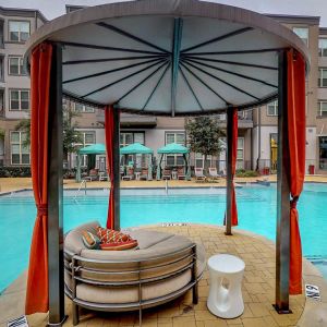 The Civic at Frisco Square apartment pool with cabanas and outdoor seating