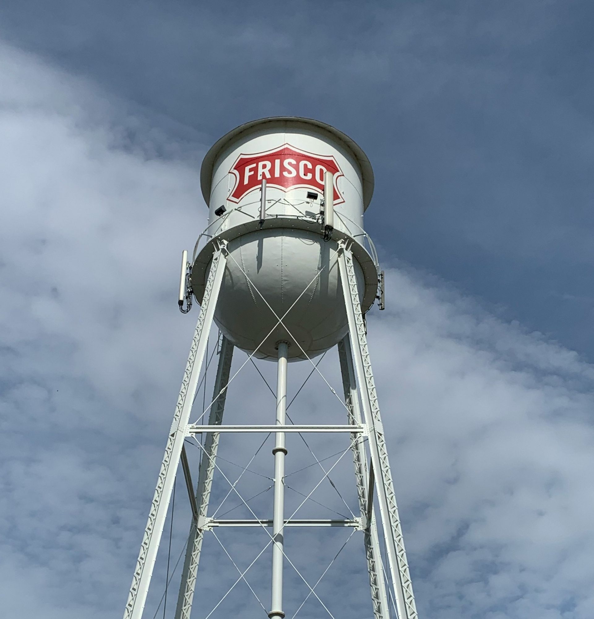 White water tower with red sign in Frisco, TX