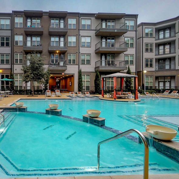 Luxury resort-style pool with cabanas and tanning ledge at The Civic at Frisco Square