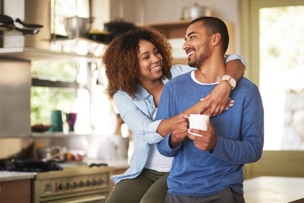 Happy young couple feeling relaxed in their kitchen at home